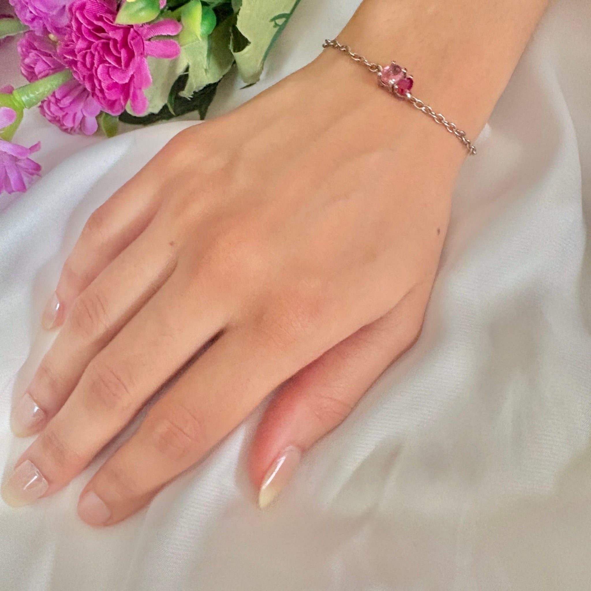 Close-up of bonded cut bracelet featuring light and dark pink stones

