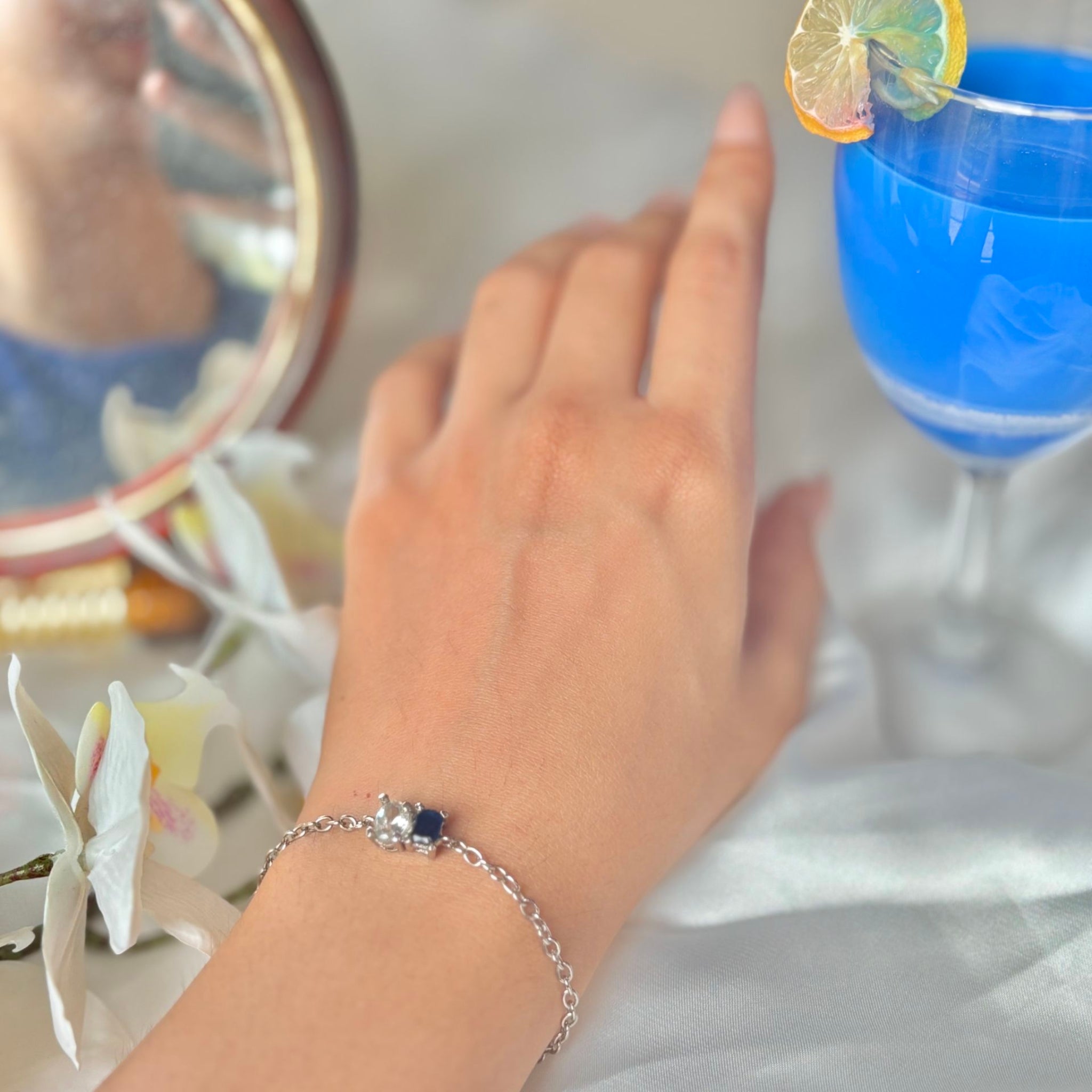 Elegant blue fizz bracelet featuring blue and white stones on wrist

